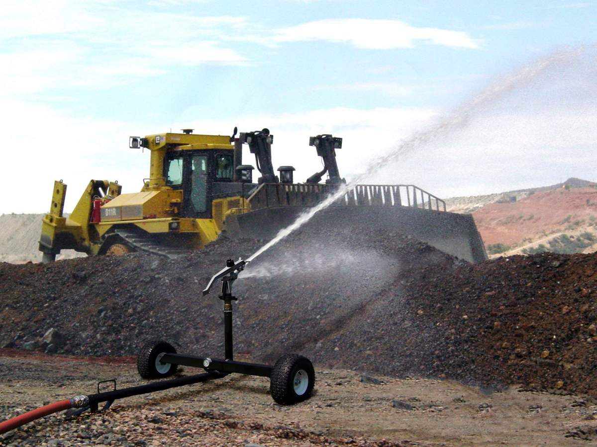 sprinkler at construction site with equipment in background