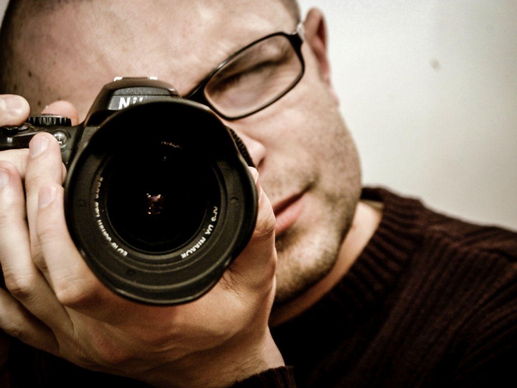 Close up shot of a photographer taking shots with his camera for a photo contest